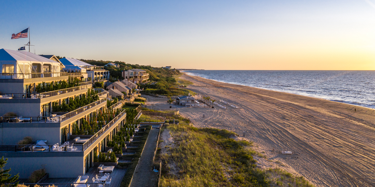 Drone view of Gurney's Montauk Resort and private beach at sunset.