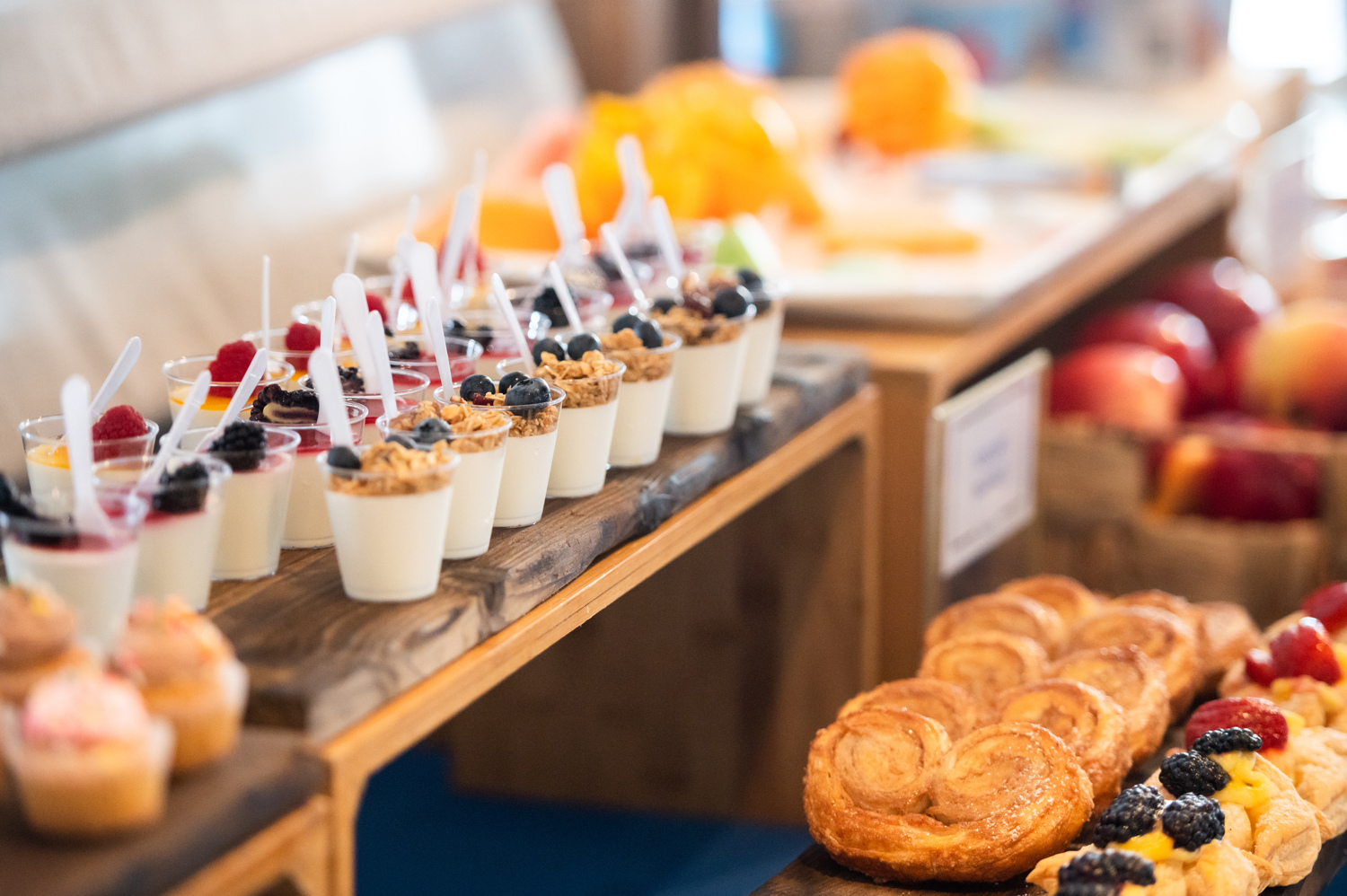 A buffet setup including parfaits and pastries