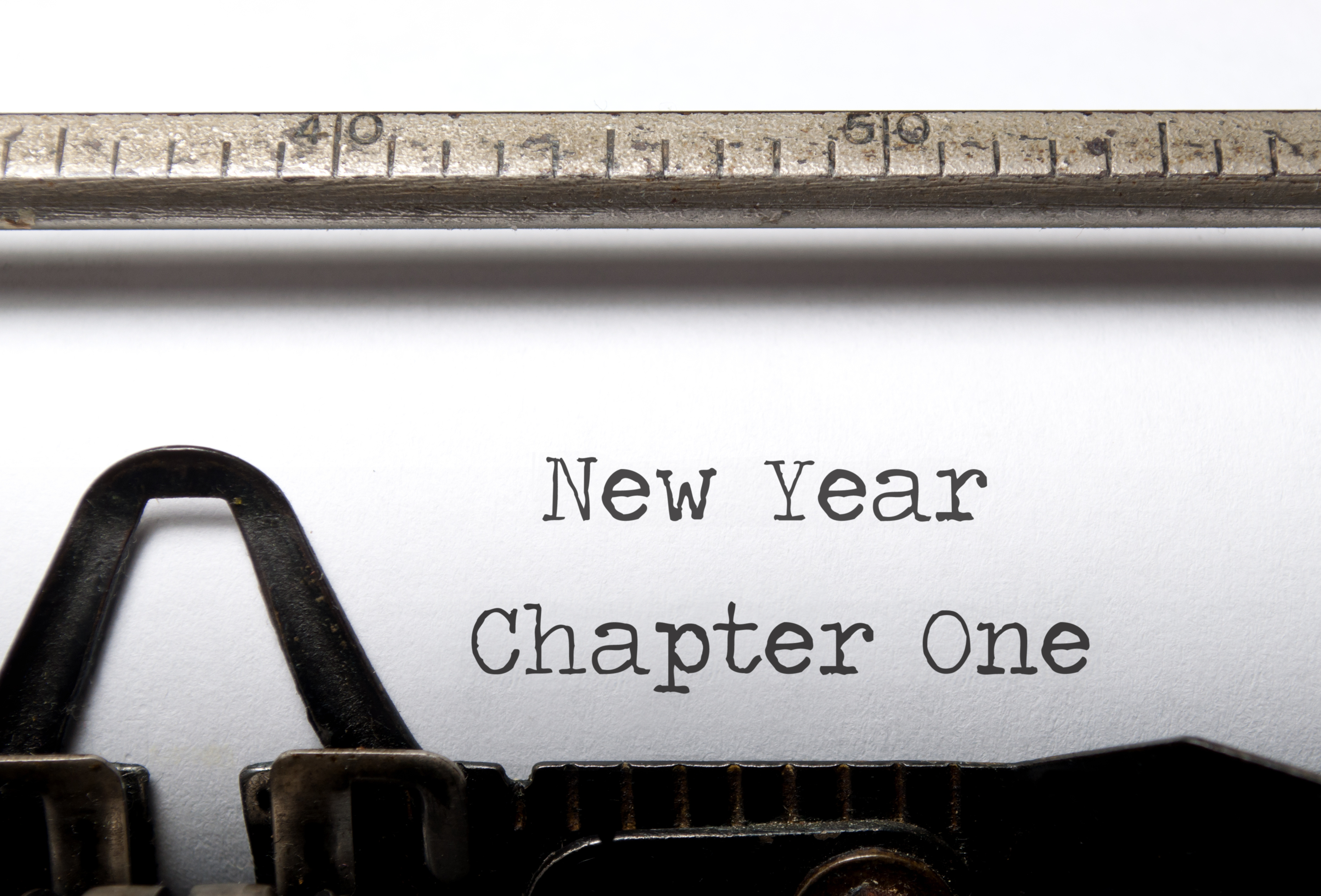 Closeup of typewriter page with "New Year. Chapter One." typed on page.