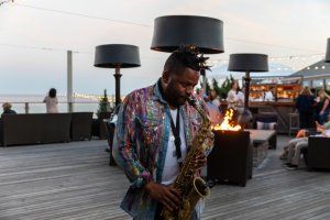 Man playing saxophone at The Firepit.