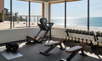Seawater Spa Fitness Center with free weights and ocean view.