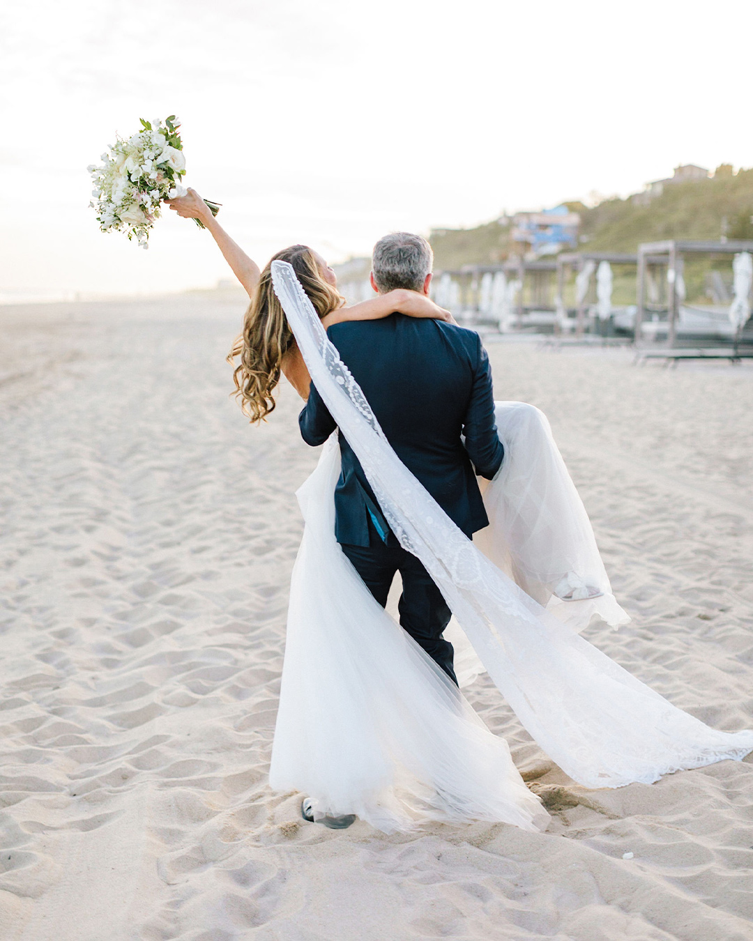 Couple walking down a beachside