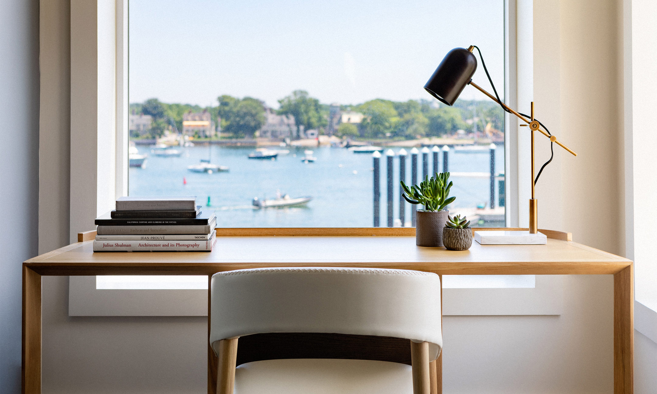 chair at desk with lamp overlooking marina