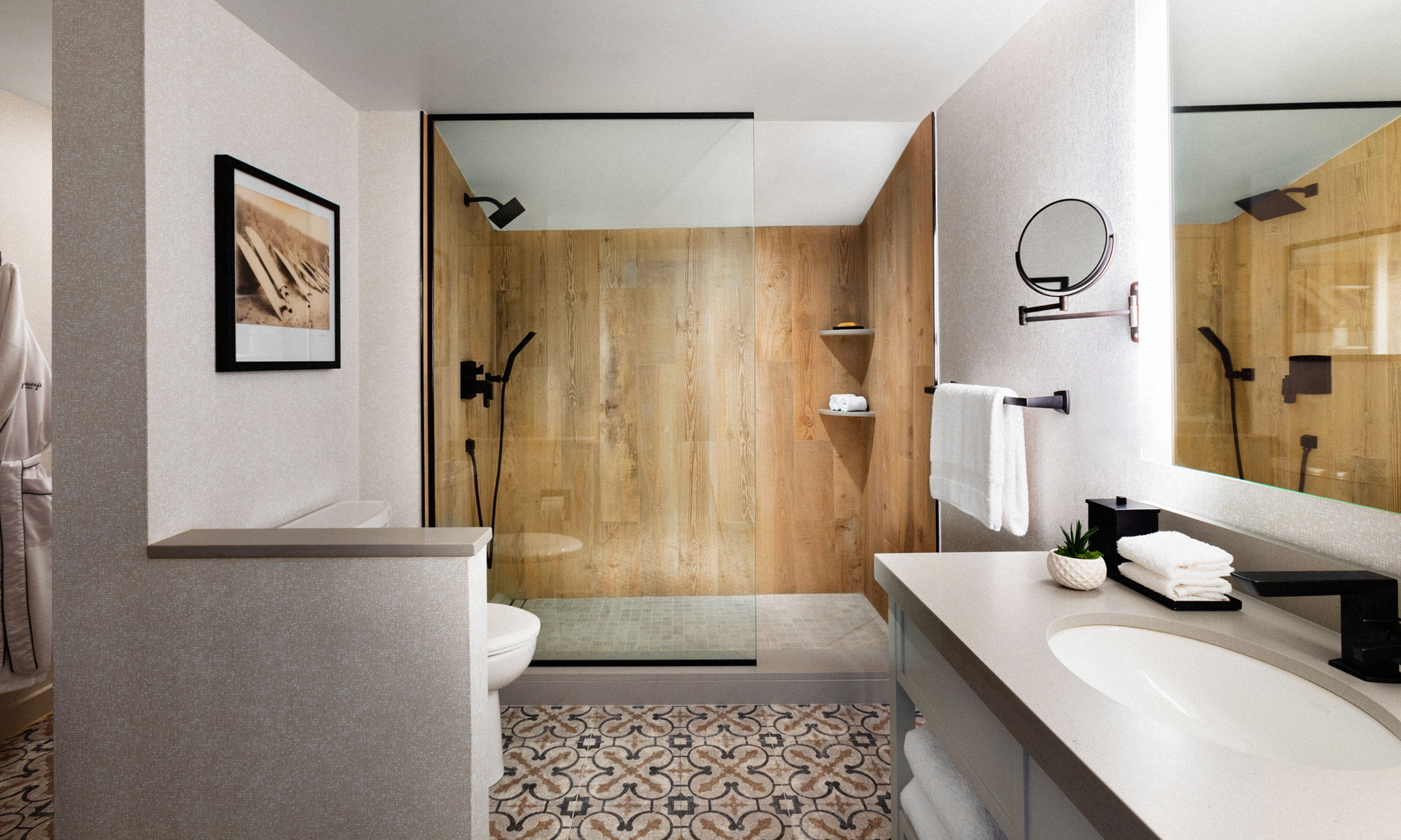 bathroom with wood wall shower, sink and mirror