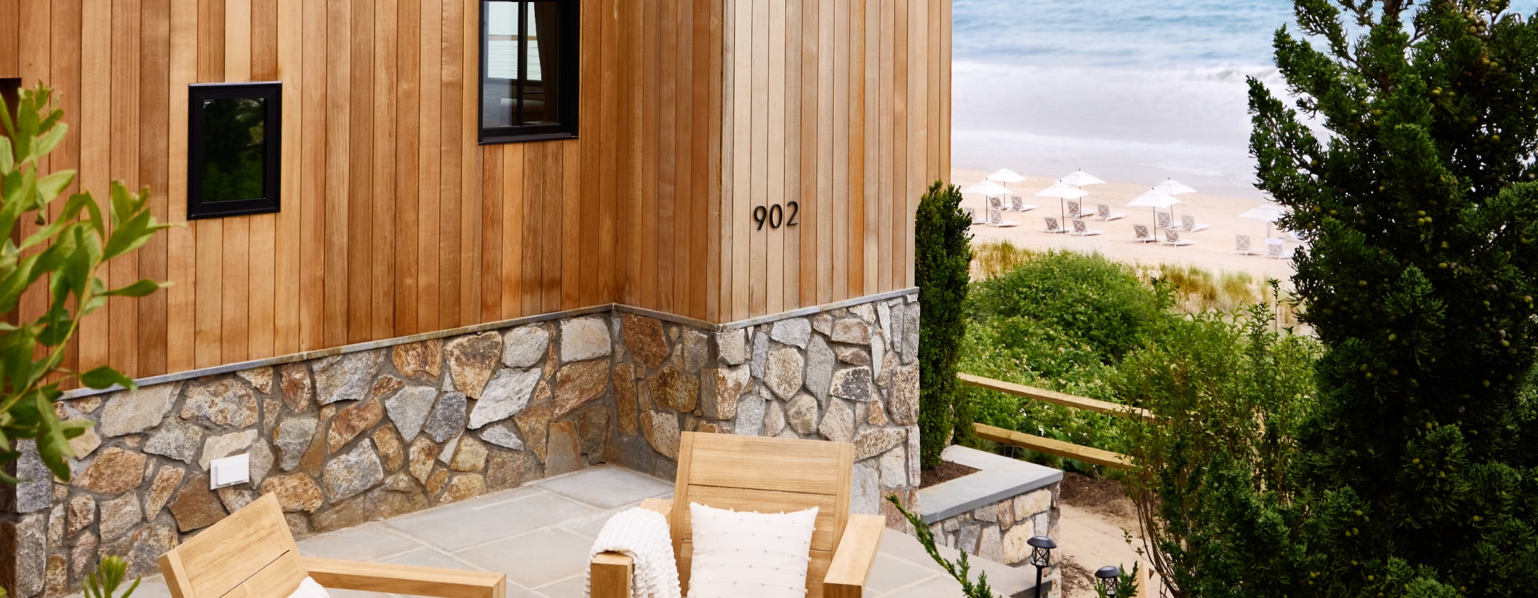 A beachfront building with a patio area and ocean view