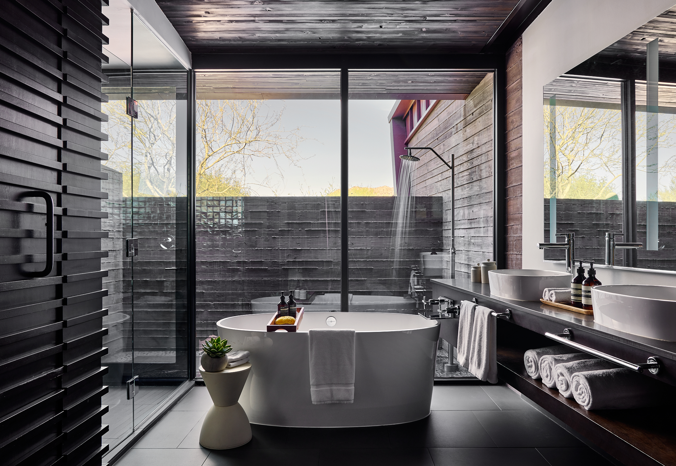 Bathroom with two sinks, vanity, soaking tub and outdoor shower.