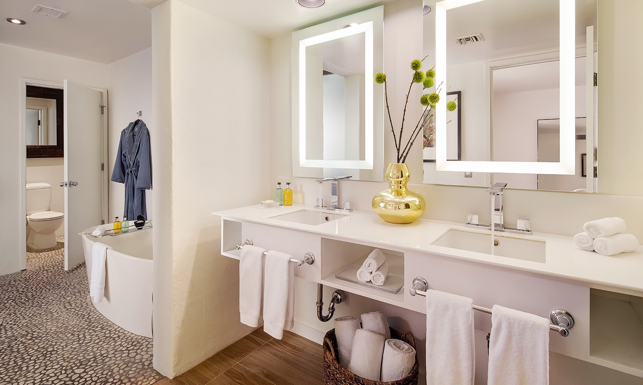 Bathroom with two sinks, two vanities, oversized soaking tub and toilet.