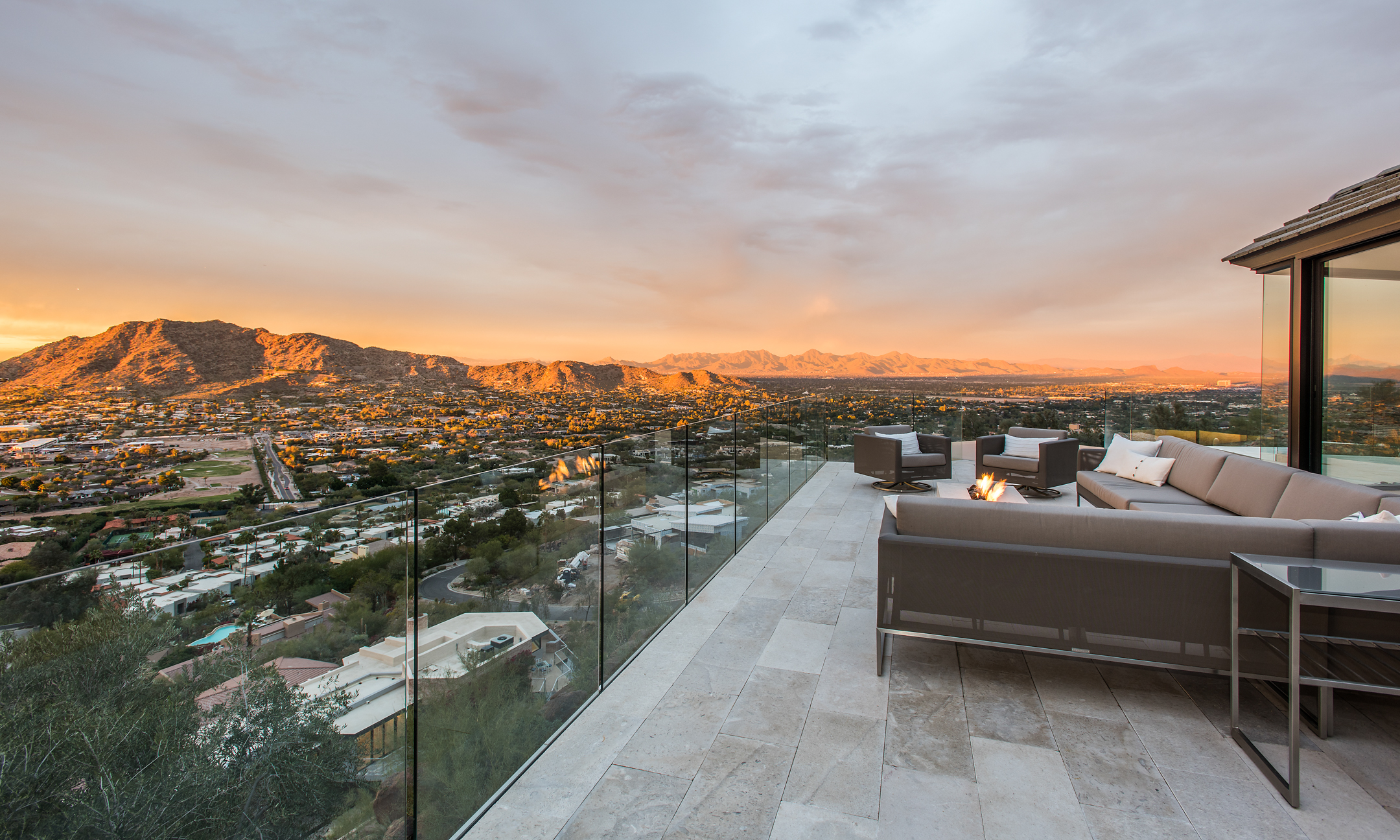 Wrap-around patio with couch, fire pit and valley views.