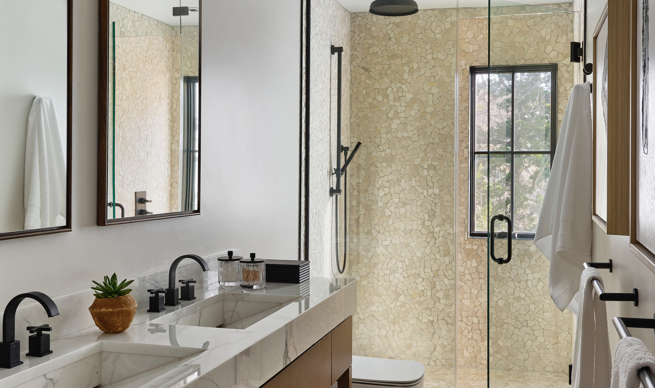 Bathroom with two sinks, two vanities, and walk-in shower.