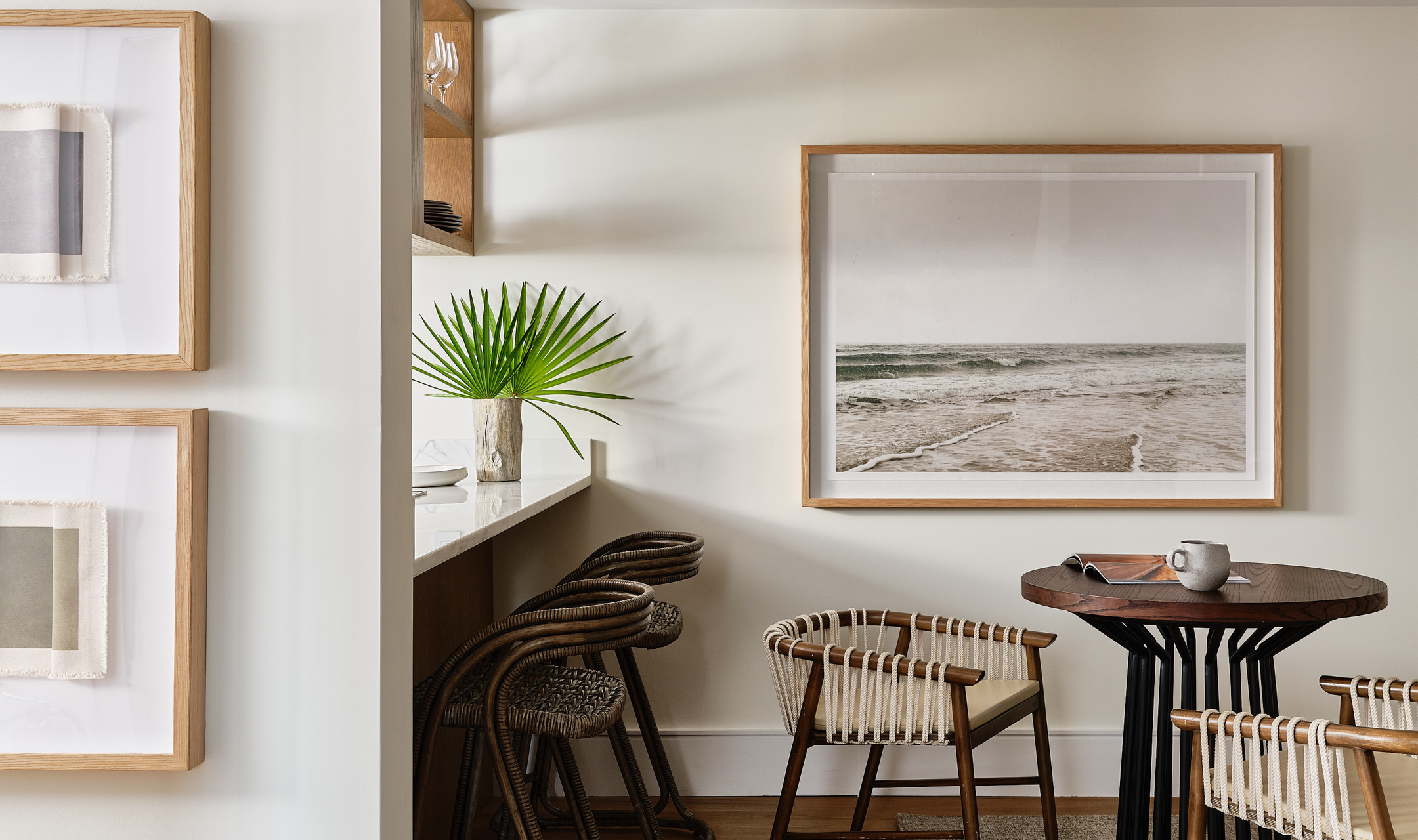 Kitchen seating area with beach themed artwork.