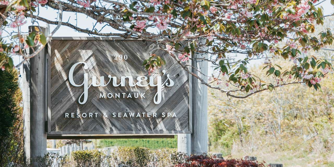 Gurney's Montauk sign surrounded by springtime blooms.