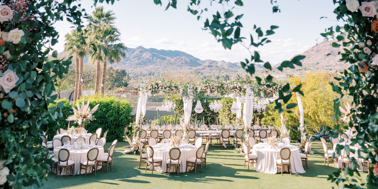 Wedding lawn set up for dinner reception with stunning mountain backdrop.