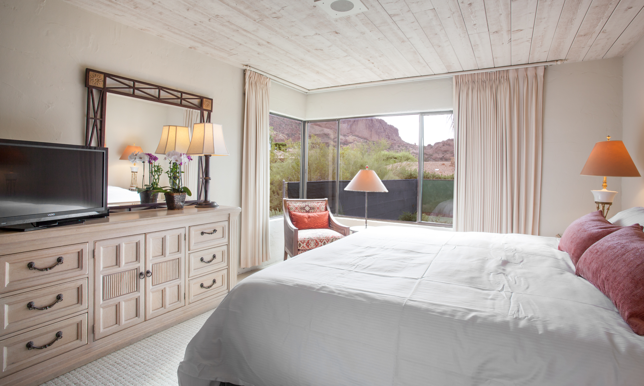 Villa Norte master bedroom with king bed, television and view of Camelback Mountain.