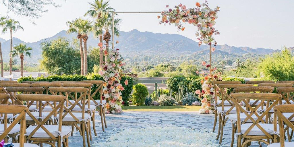 Ceremony on Paradise Views patio with scenic mountain backdrop.