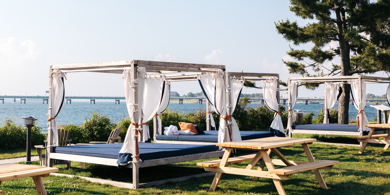 Cabanas and picnic tables with scenic ocean view.
