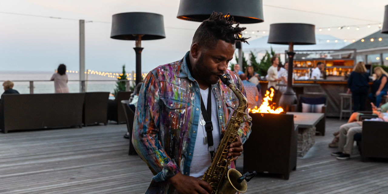 Man playing saxophone at The Firepit.