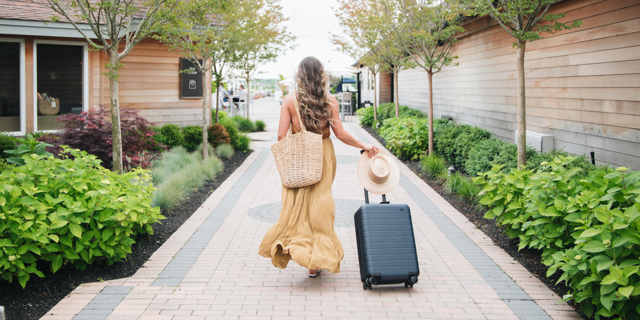 Woman walking with luggage.