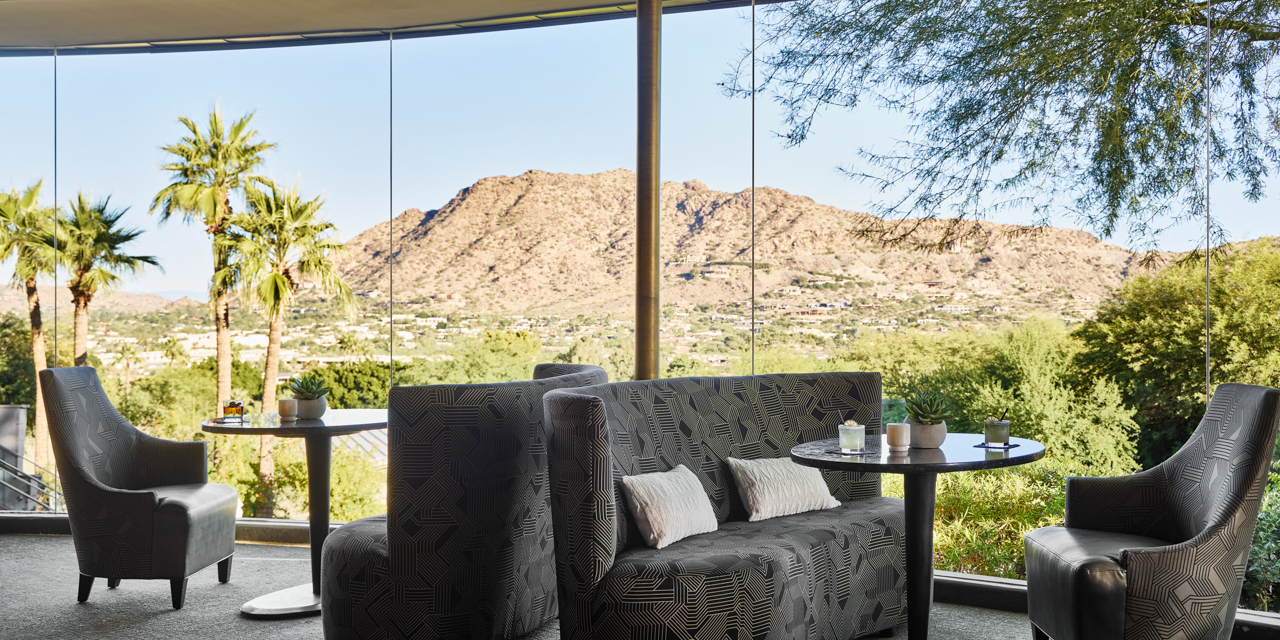 Jade bar seating area with couches and stunning valley views.
