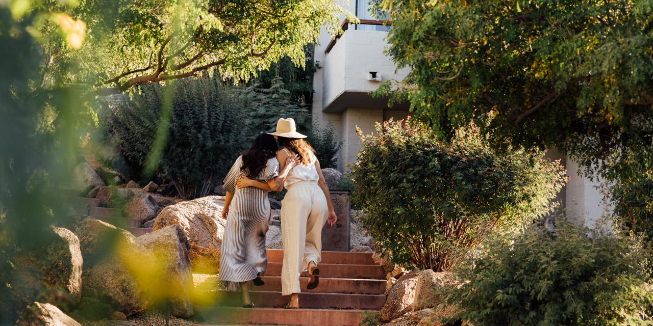Girlfriends enjoying a moment as they walk through Mountain Casitas and Suites.