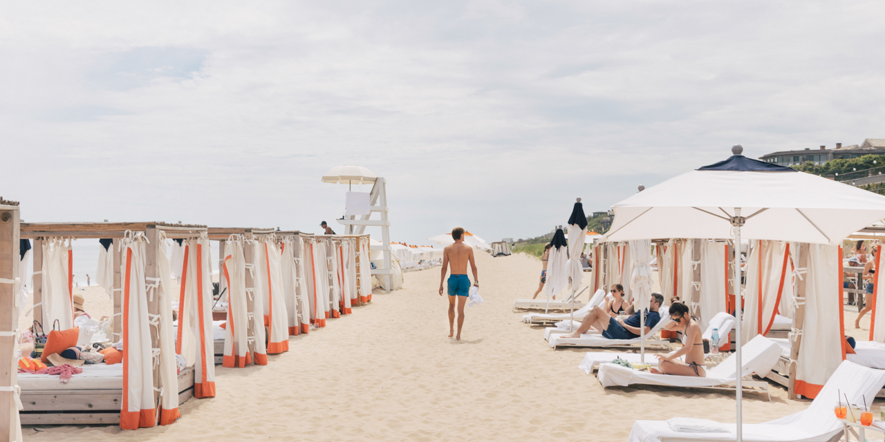 Man walking down Gurney's Montauk private beach.