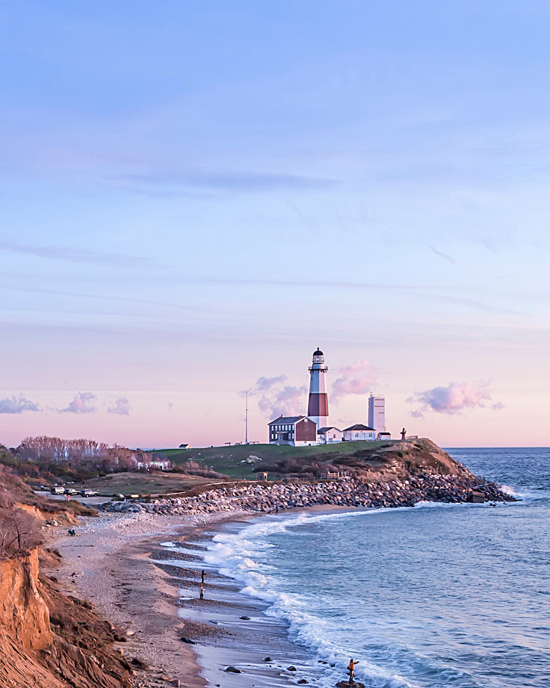 Shoreline of Montauk at fall with beach and Montauk lighthouse in background.