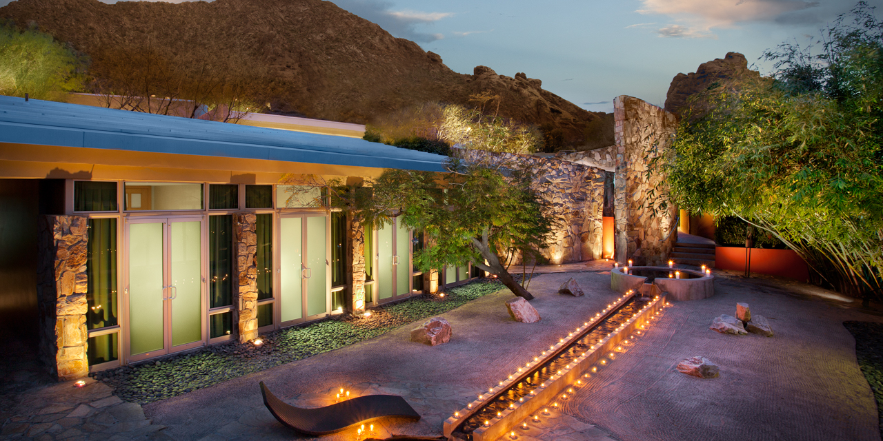Overhead view of Sanctuary Spa's Zen Garden lit with candles at dusk.