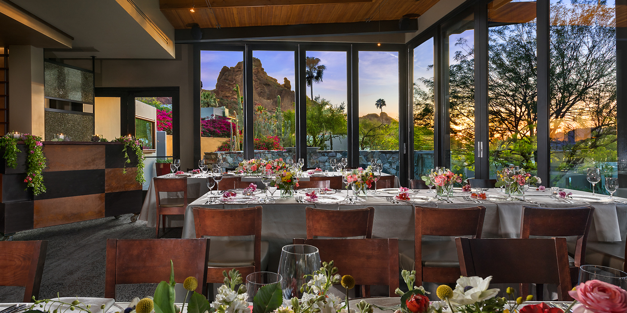 Elements' Praying Monk Dining Room decorated with spring florals and sun setting behind Praying Monk.