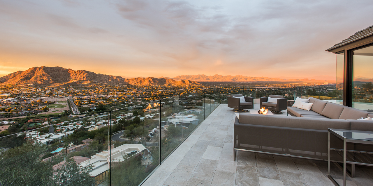 View from Villa Ventana patio at sunset with couch and fire pit.