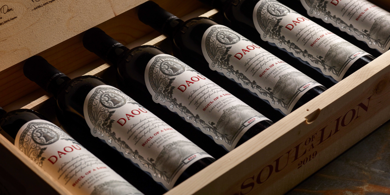 Bottles of Daou wine lie lined up in a wooden box.