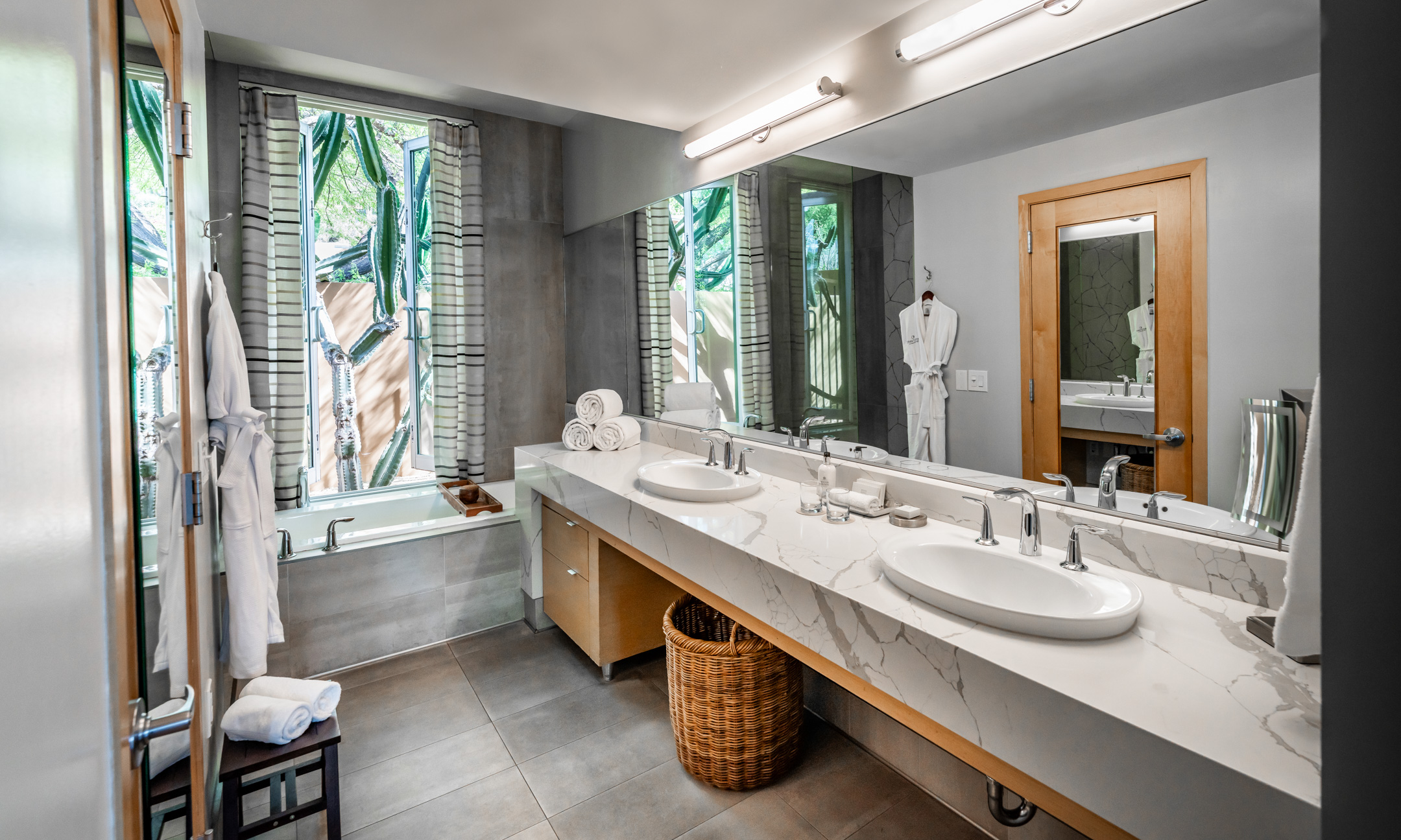 Spa Casita bathroom with two sinks, vanity with light, bathtub and separate shower.