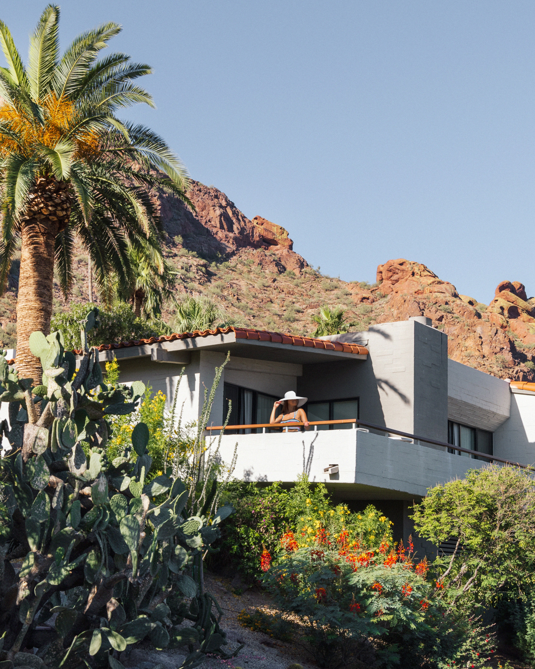 Woman enjoying view from Mountain Suite patio nestled on Camelback Mountain.