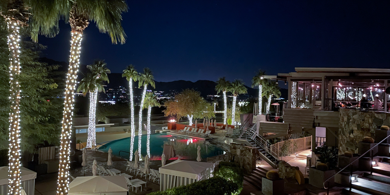 Night view of Infinity Pool and elements restaurant decorated with holiday lights.