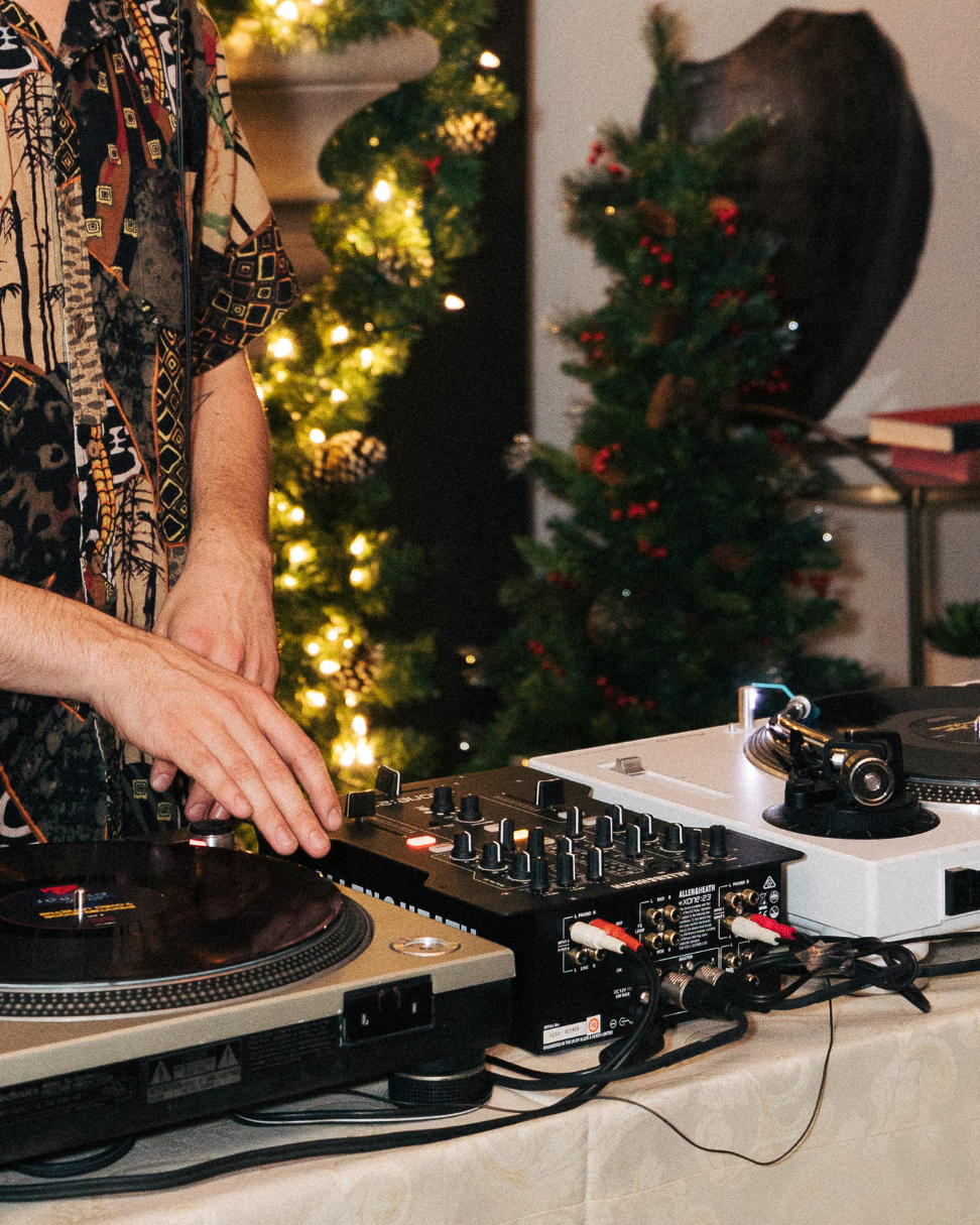 A closeup of a DJ mixing at a turntable.