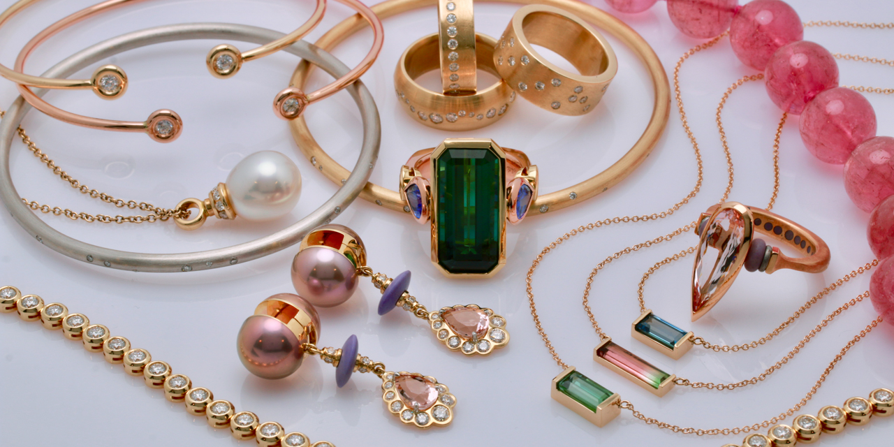 A display of custom earrings, bracelets, necklaces and rings from Raintree Jewelry.