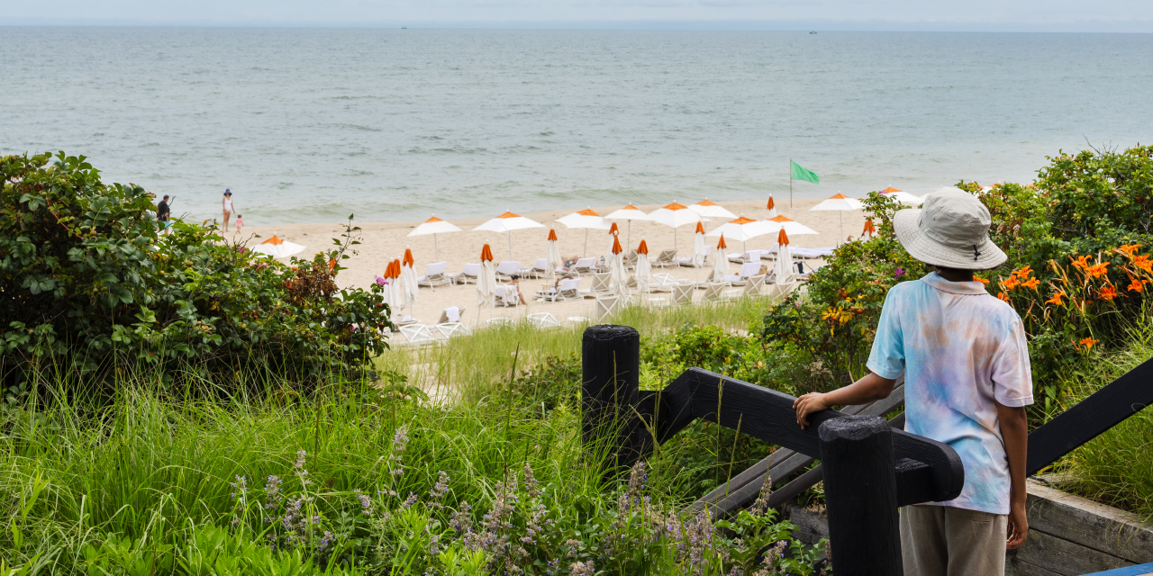 A boy looks out over the beach at Gurney's Montauk Resort