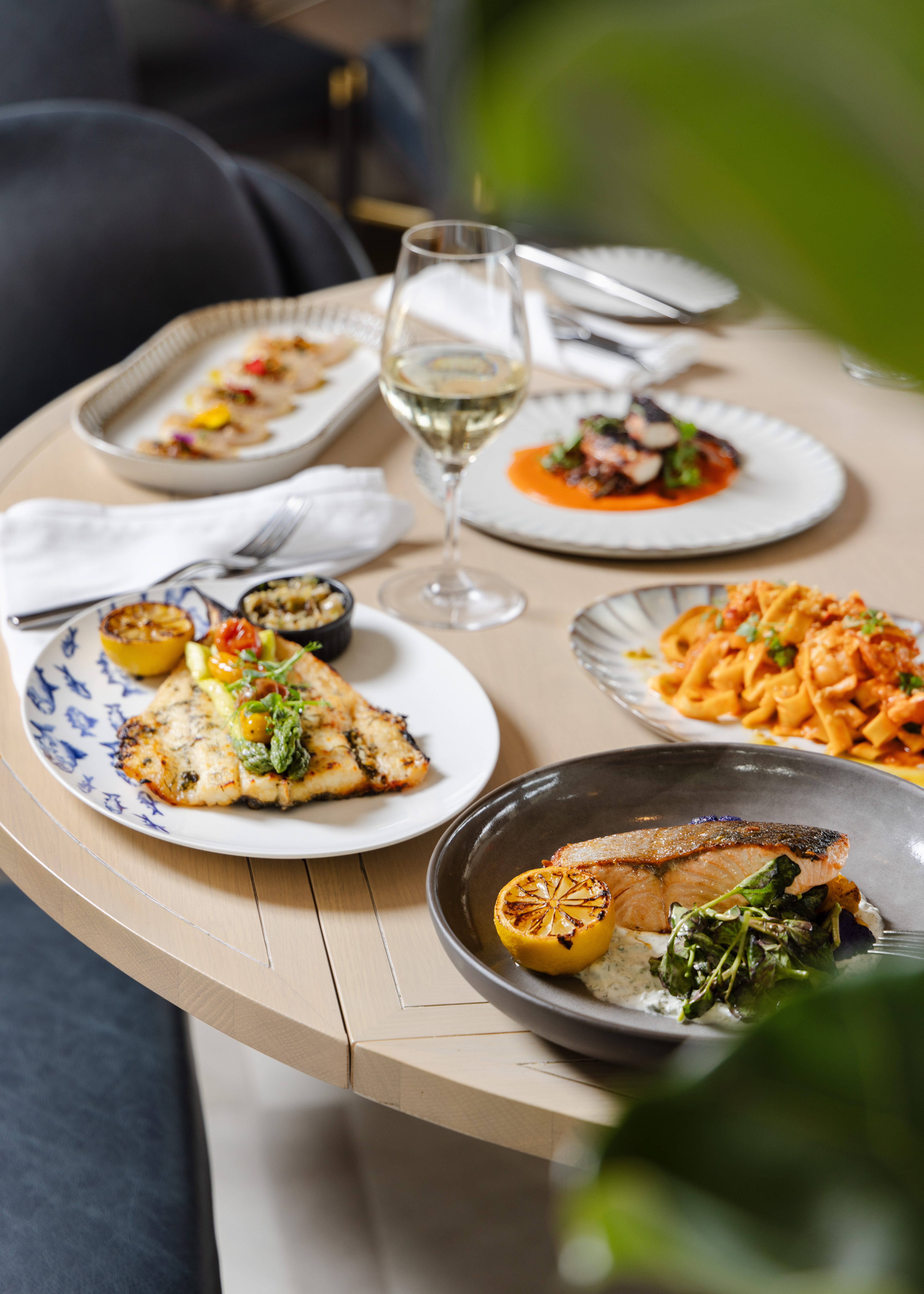 This is a table full of plates of food. 