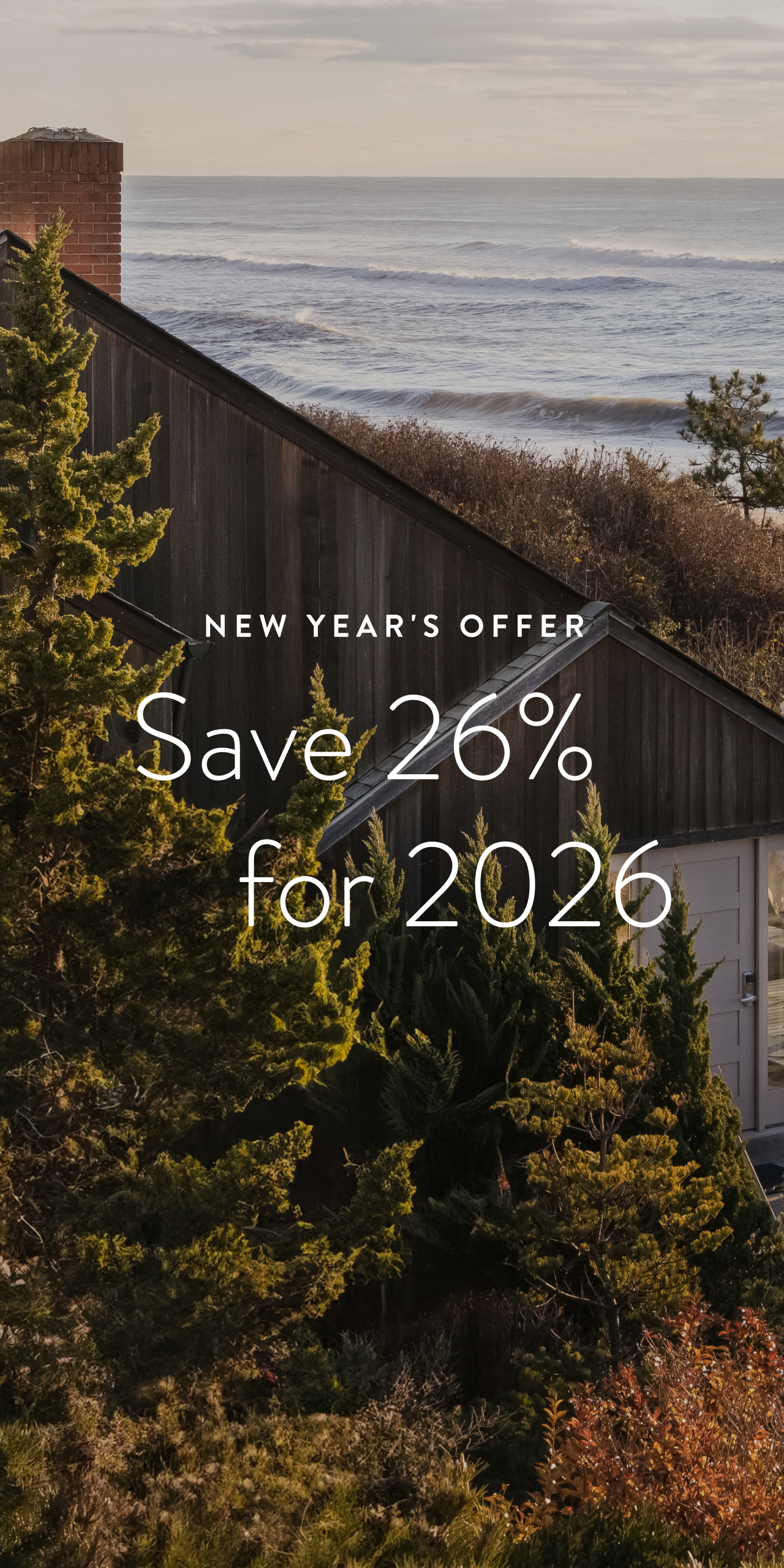 Save 26% for 2026 text over image of grass overlooking the beach