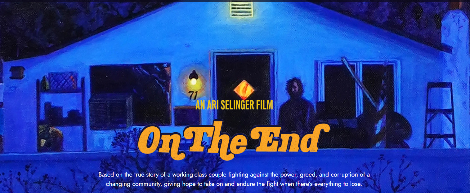 Blue-lit building at night with text "On The End" in yellow.