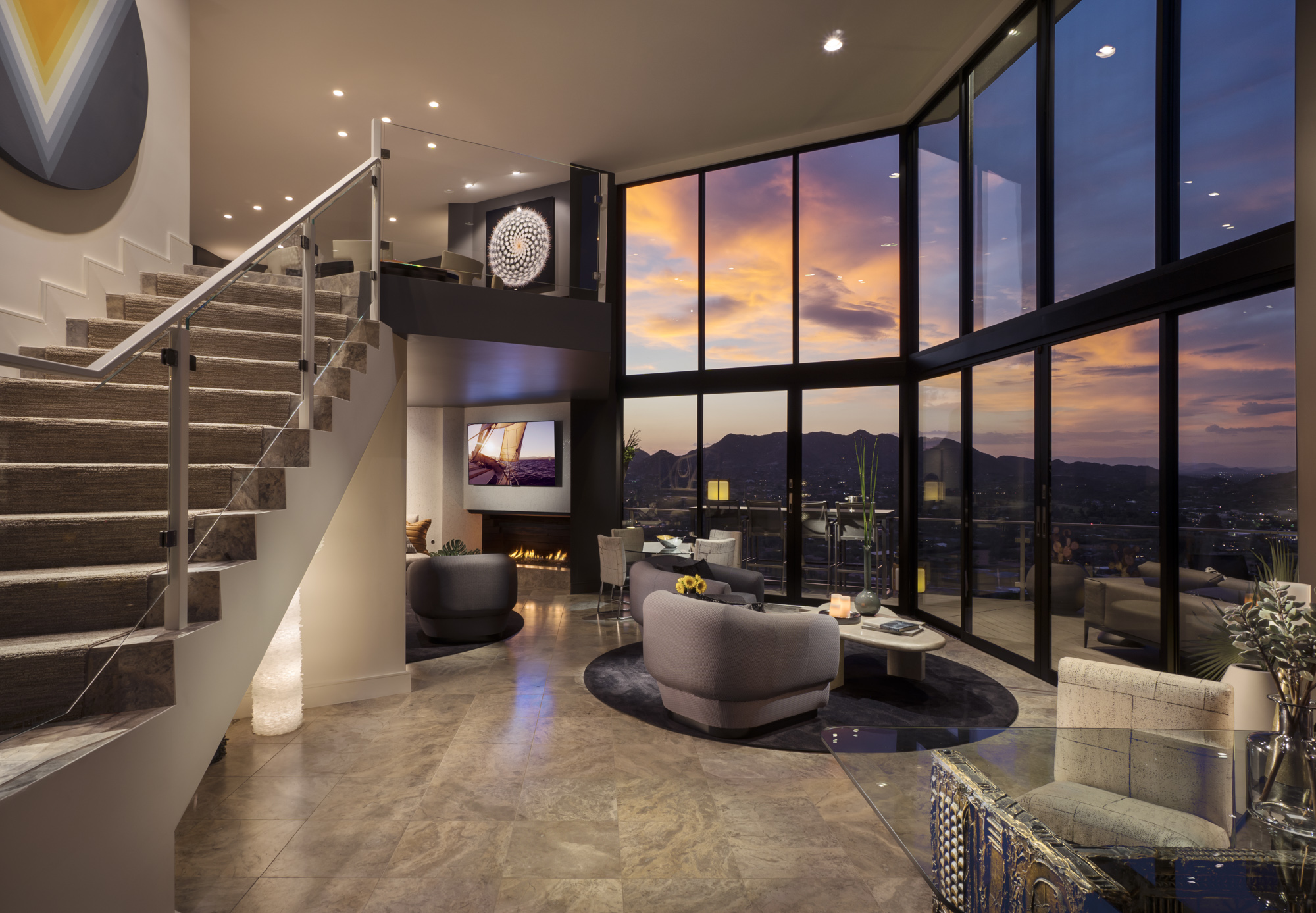 Villa Luna downstairs living room with couch and chairs, television nook, and floor-to-ceiling windows showing Valley view.