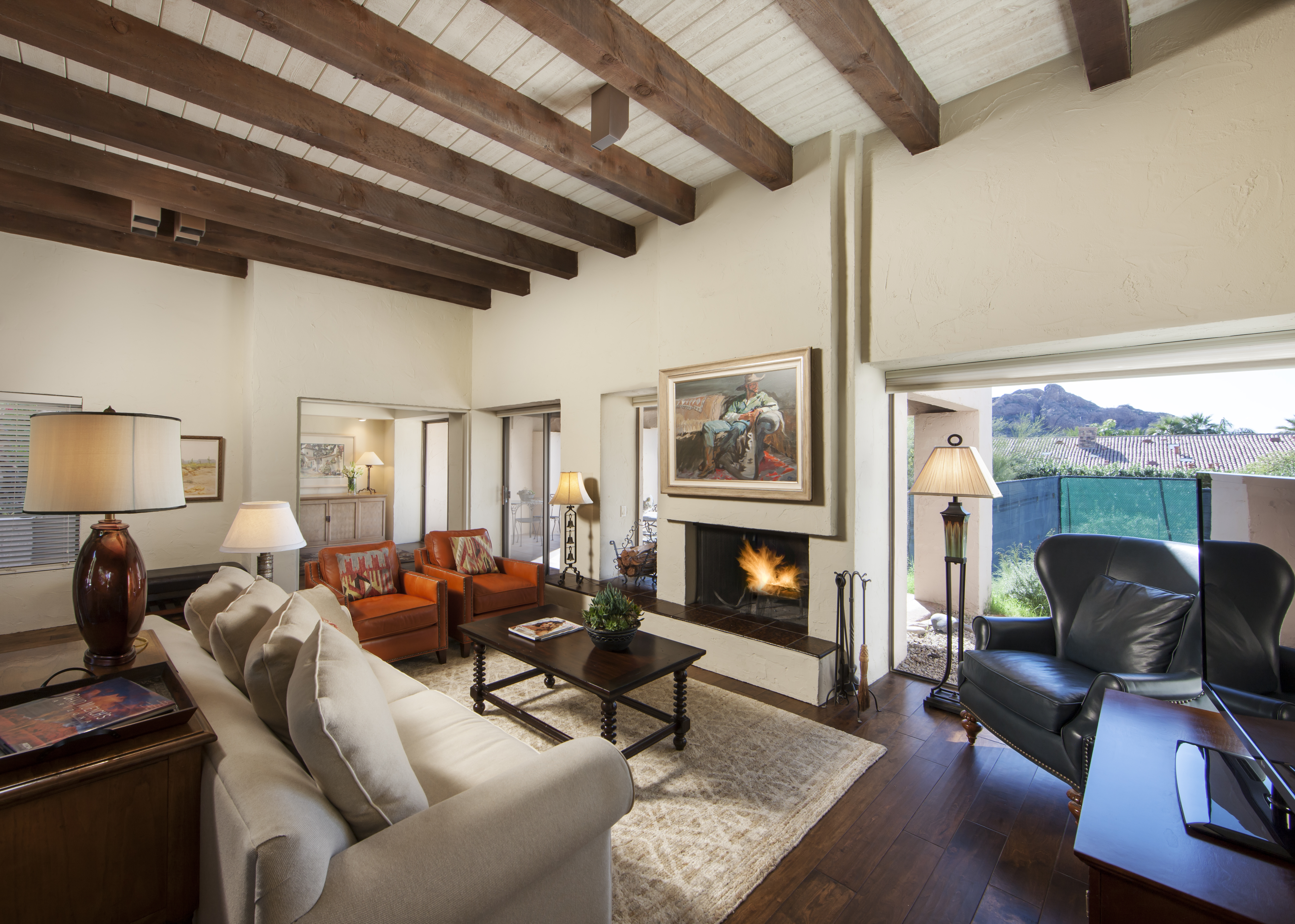 Villa Norte living room with southwestern couch and chairs, fire place and television.