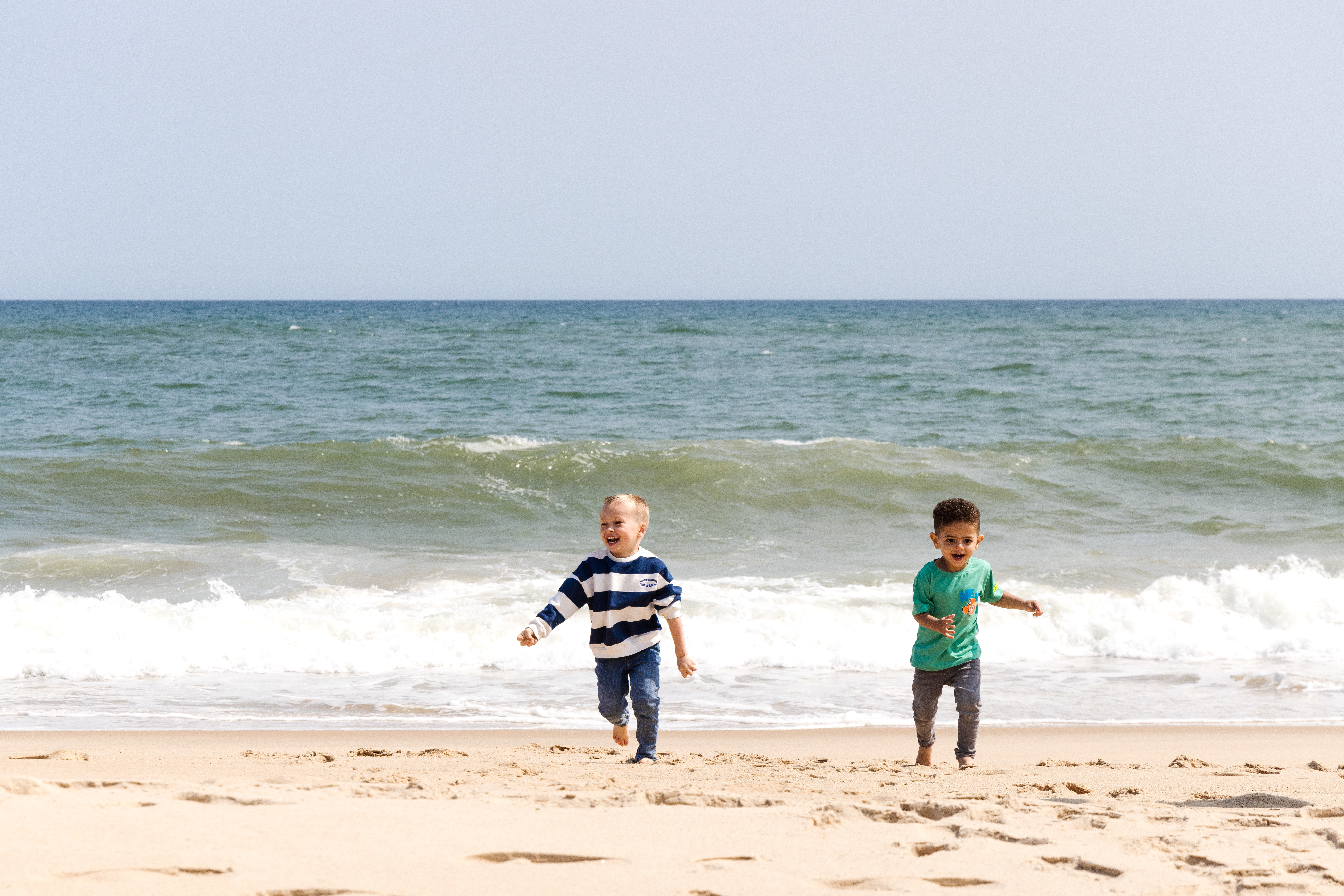 Children run on the beach at Gurney's Montauk Resort