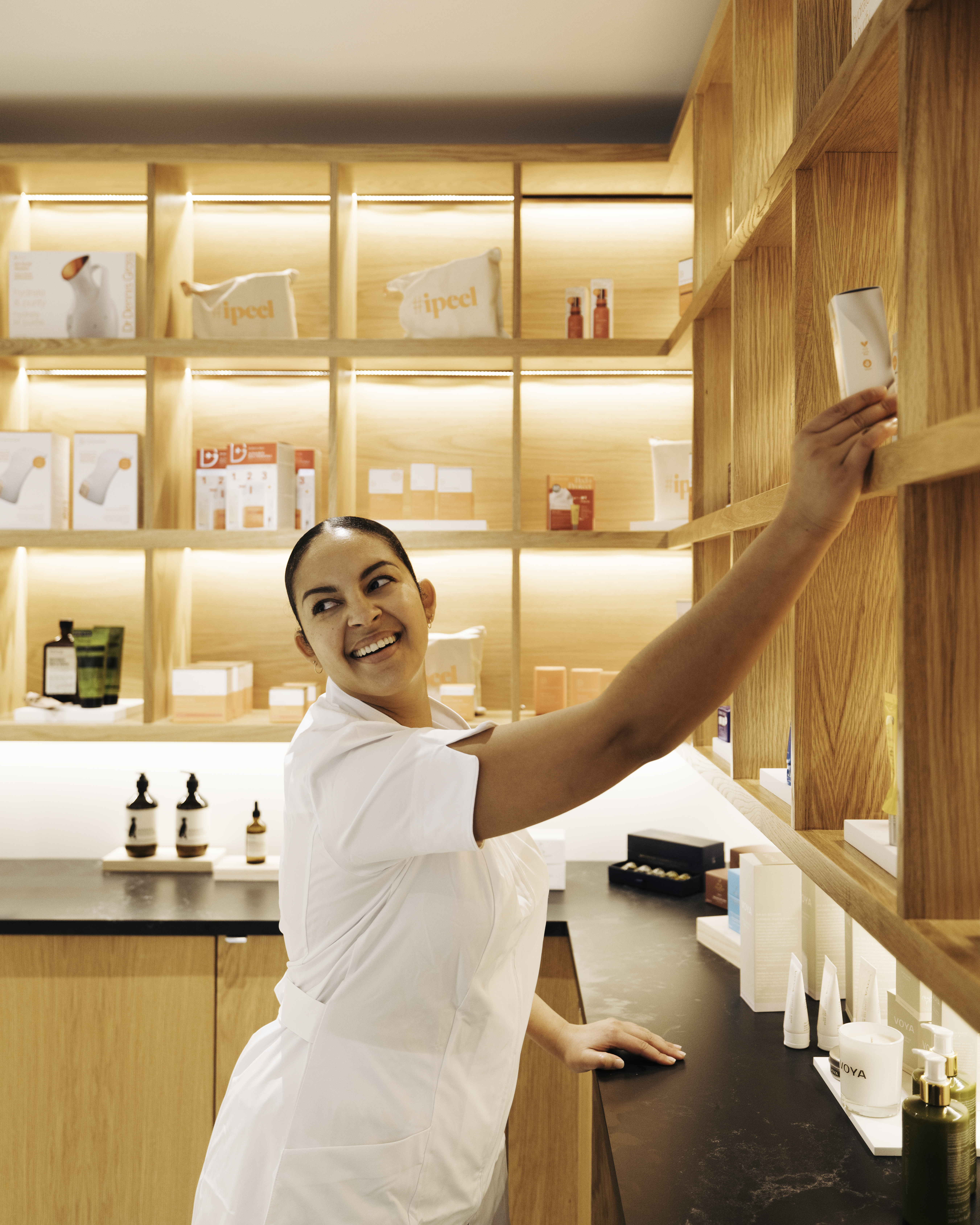 Woman at Seawater Spa happily selecting a product for a guest.