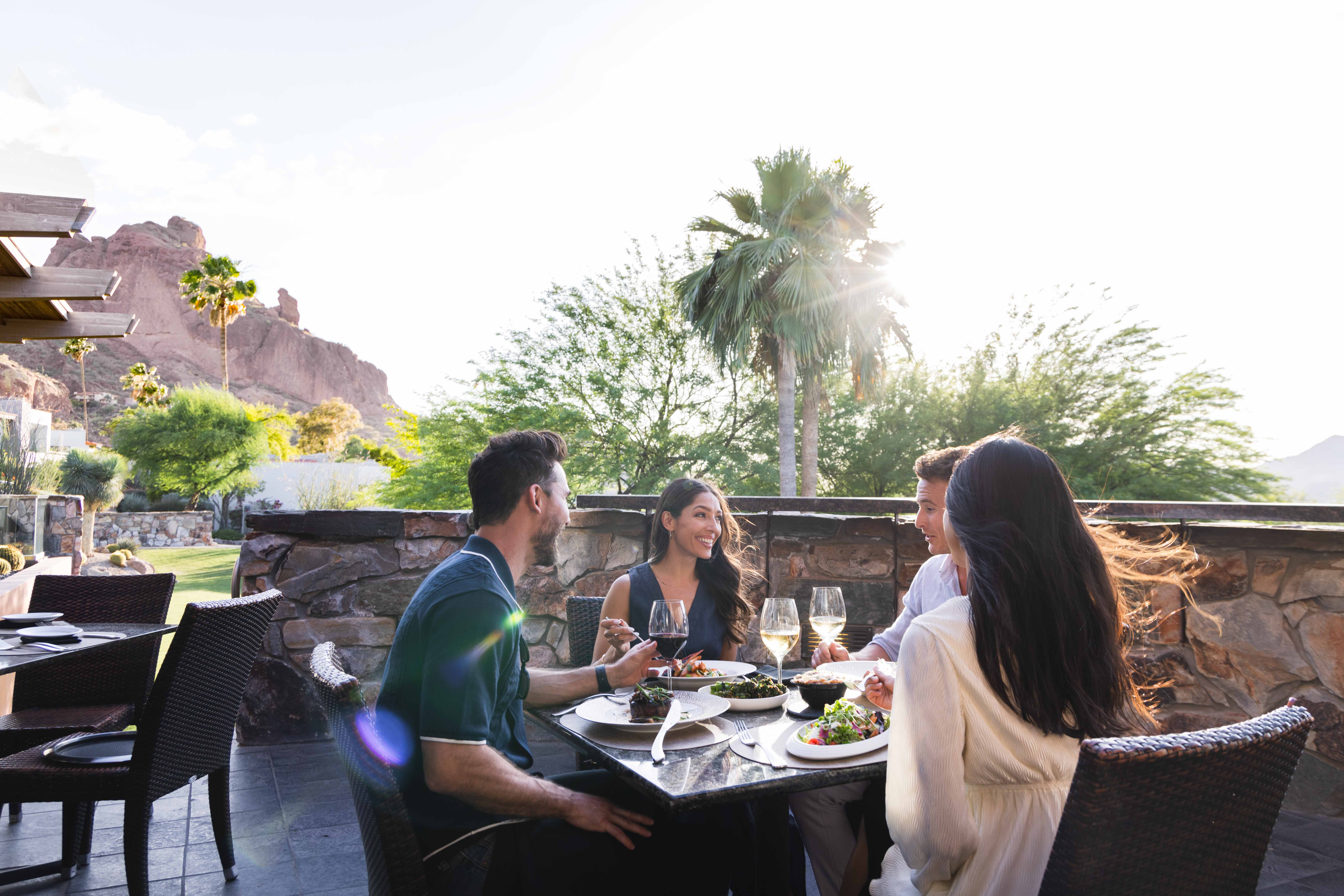 Two couples enjoying brunch on elements' outdoor sunset patio.