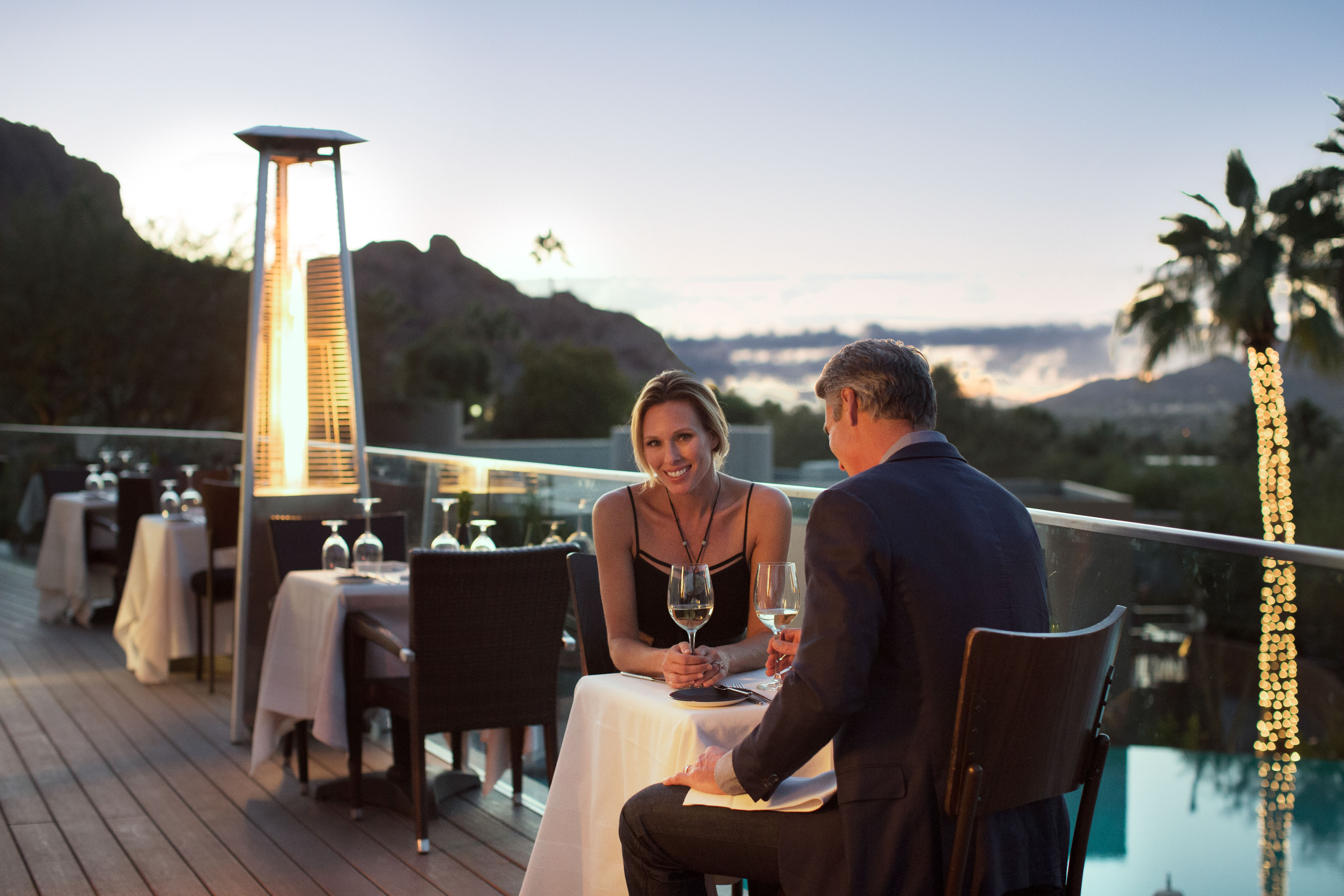 Couple enjoying sunset dinner on elements outdoor dining deck.