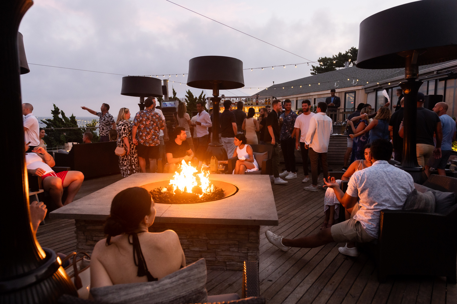 Crowd enjoying live music while lounging at The Firepit.