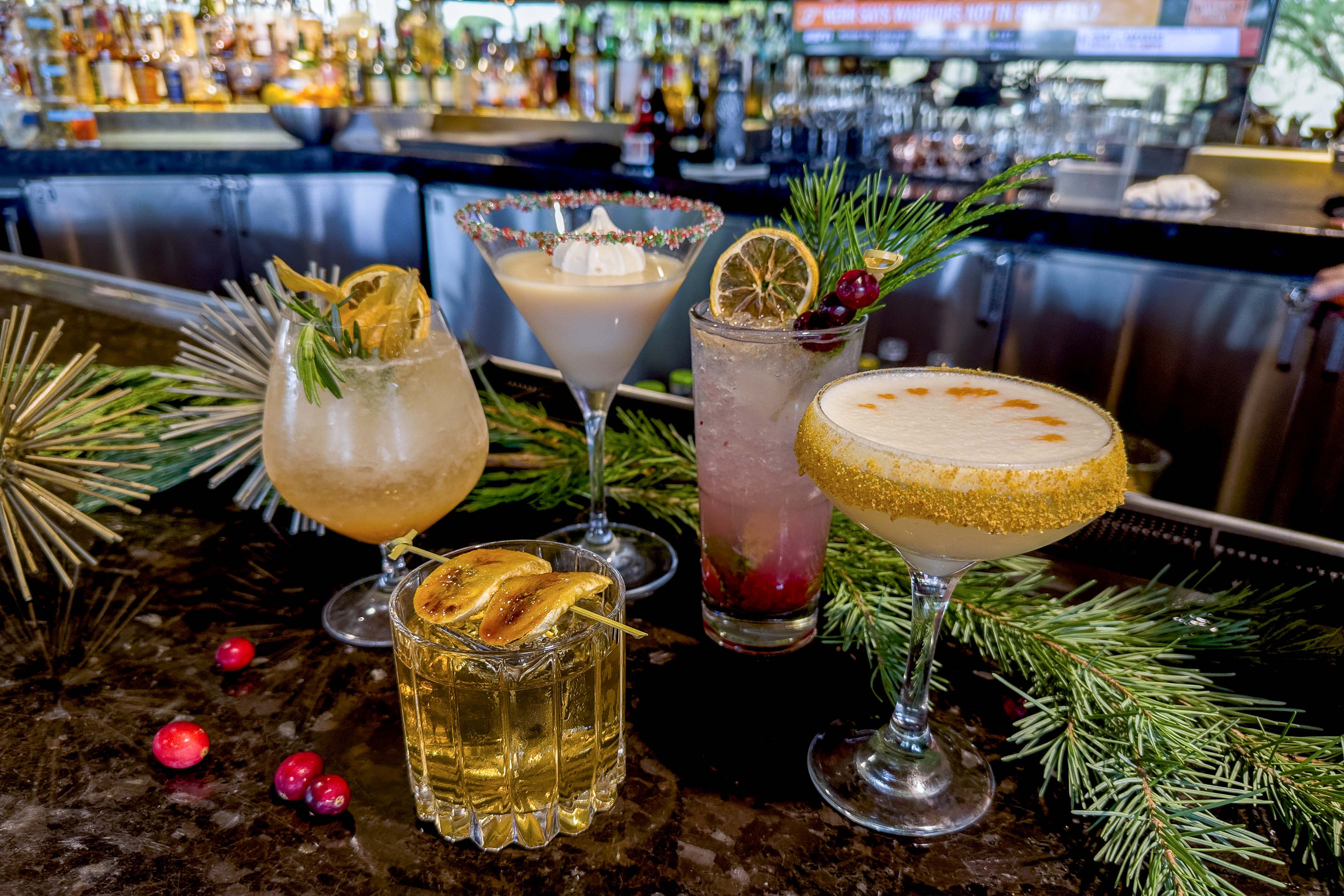 Five favorites from Sanctuary's 12 Days of Cocktails displayed on jade bar.