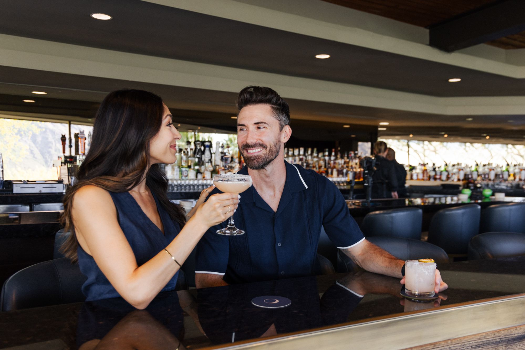 Couple enjoying cocktails at jade bar before dining in elements.