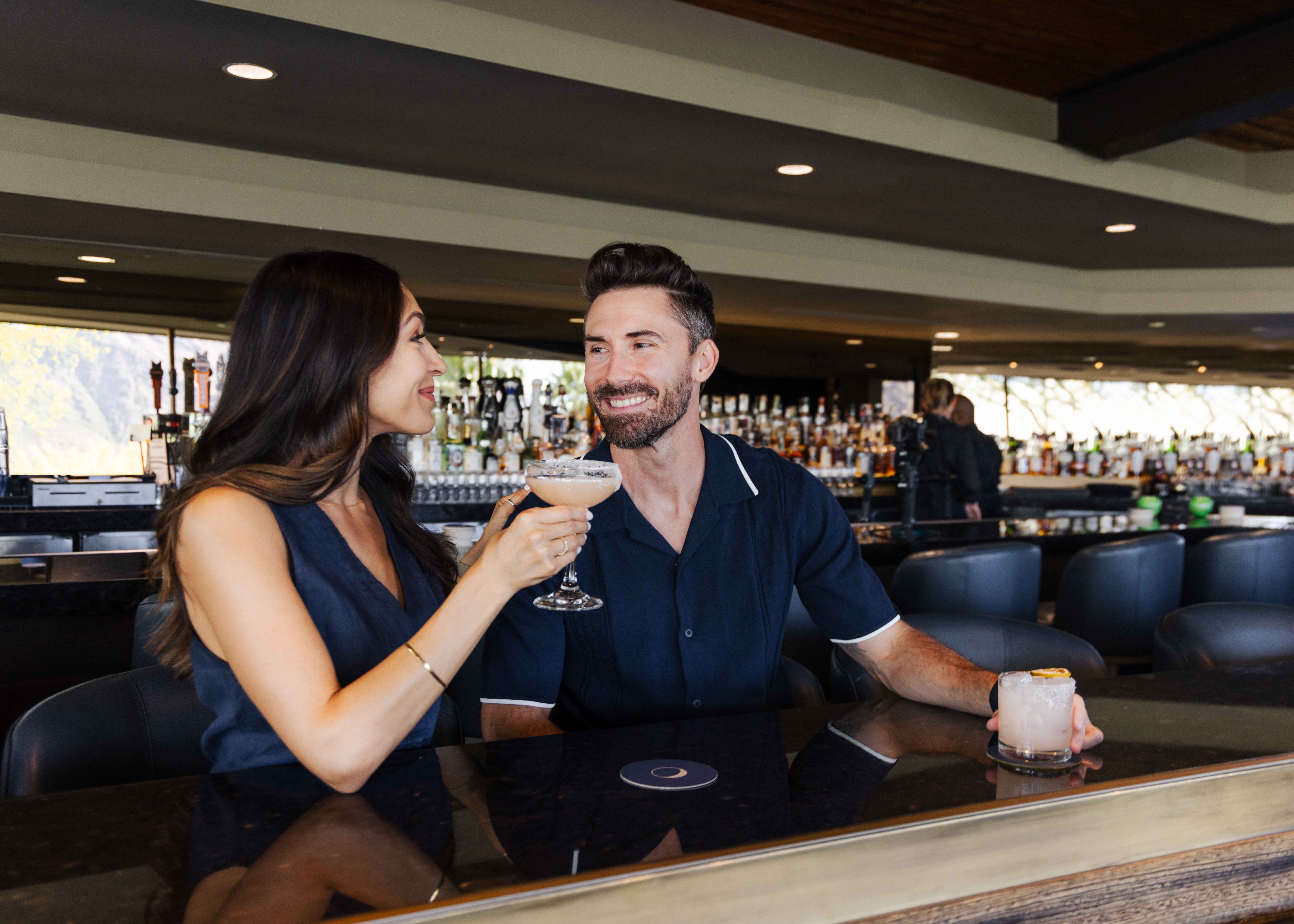 Couple enjoying cocktails at jade bar before dining in elements.