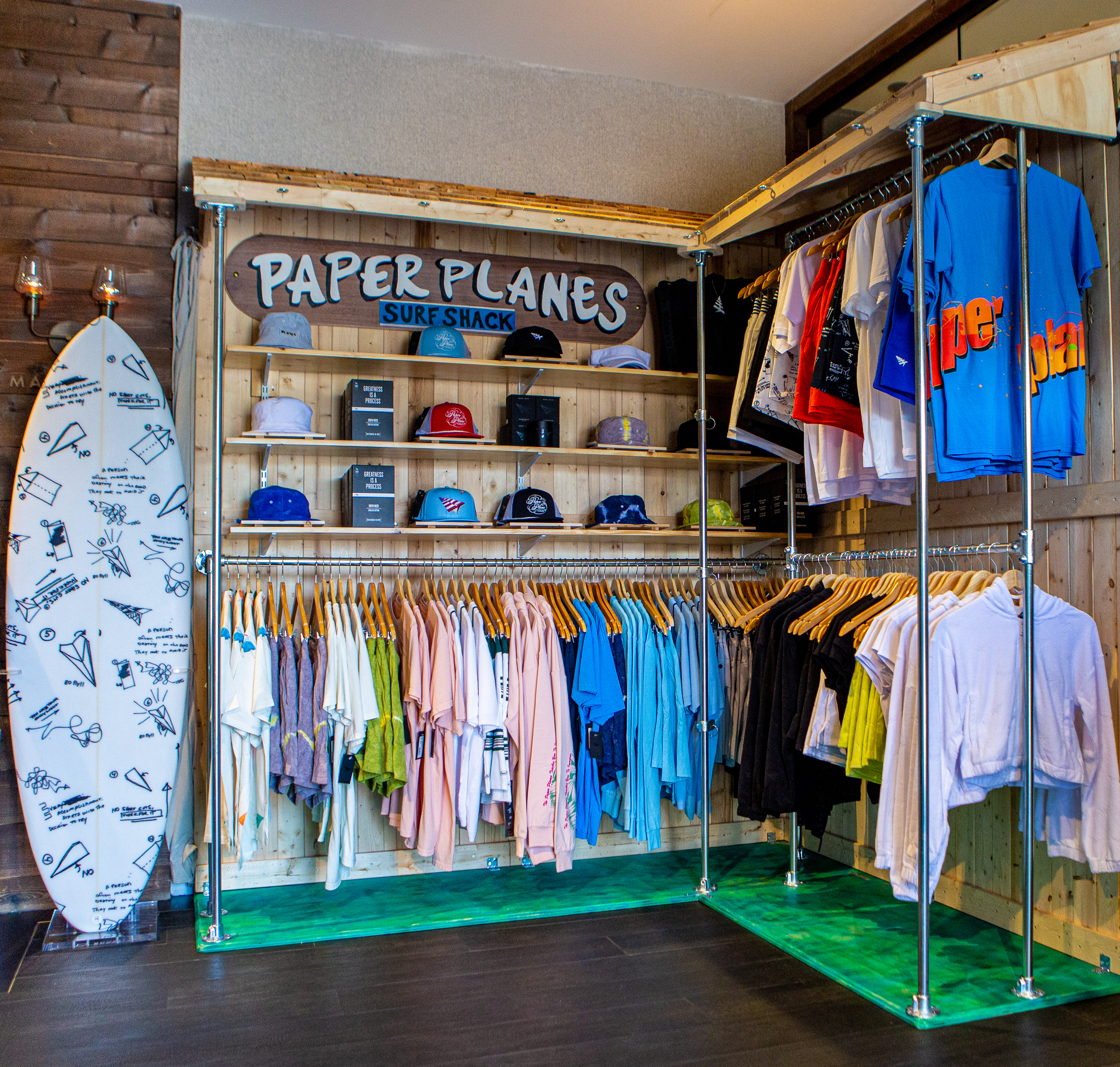 Clothing Items Hang on Racks at The Paper Planes Retail Pop-Up Shop