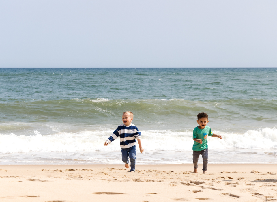 Two children run on the beach at Gurney's Montauk Resort
